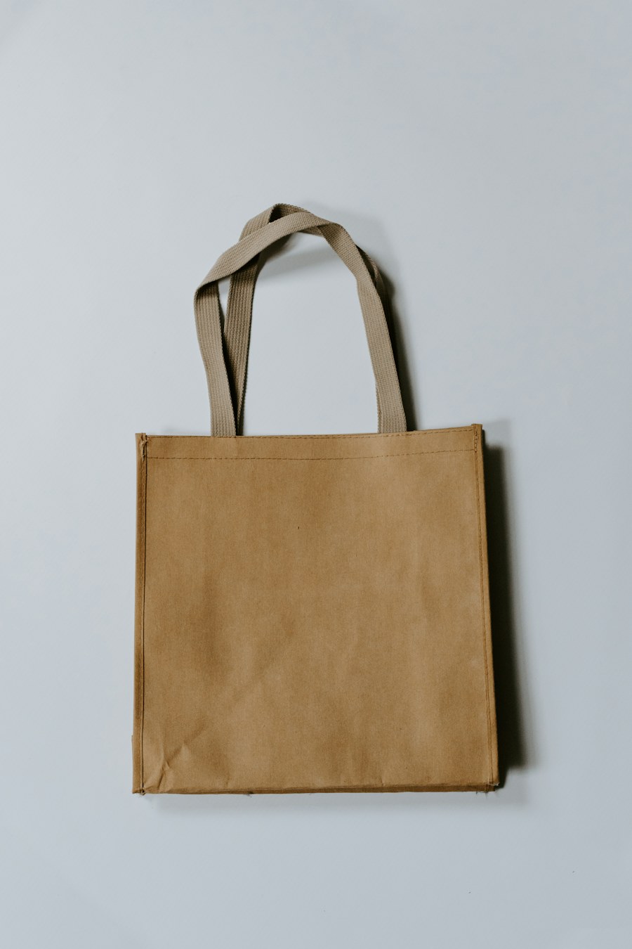 Unbleached canvas tote against a pale wall